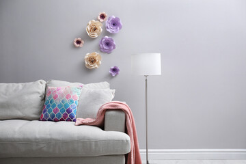 Poster - Comfortable sofa near wall with floral decor in living room