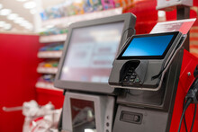 A POS Machine At Woolworths Supermarket's Self-serve Checkout Area With Blur Bokeh Background