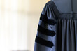 © mnirat - PhD graduate in black graduatio gown University degree