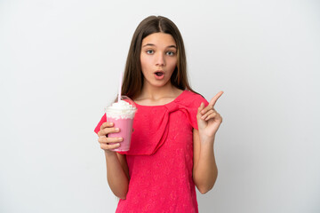 Wall Mural - Little girl with strawberry milkshake over isolated white background intending to realizes the solution while lifting a finger up