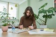 © Valerii Honcharuk - Talented creative guy teenager painting with watercolors, sitting at the table at home