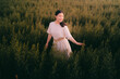 © Dearix - Portrait of young attractive teenage asian beautiful woman smile with white dress amoung grean grass and flower field in summer sunset, travel lifestyle concept for relaxation with copy space