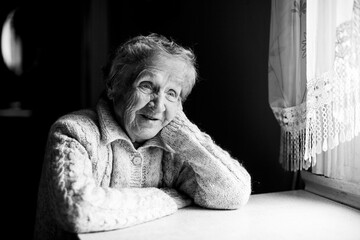 Wall Mural - Portrait of an old woman. Black and white contrast photo.