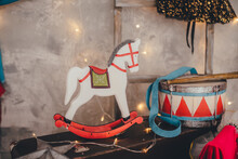 A Figurine Of A Wooden Horse On The Background Of A Gray Decorated Wall. Circus Concept. 
