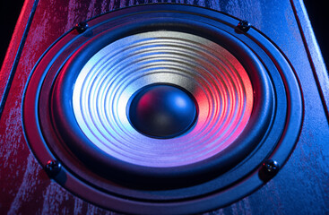 Wall Mural - Detail of sound speaker in neon light on black. Close-up.