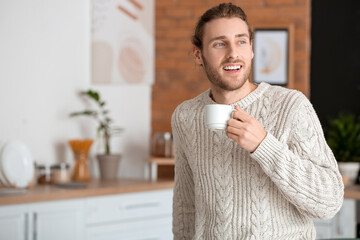 Poster - Handsome young man drinking coffee at home