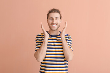 Poster - Smiling young man on color background