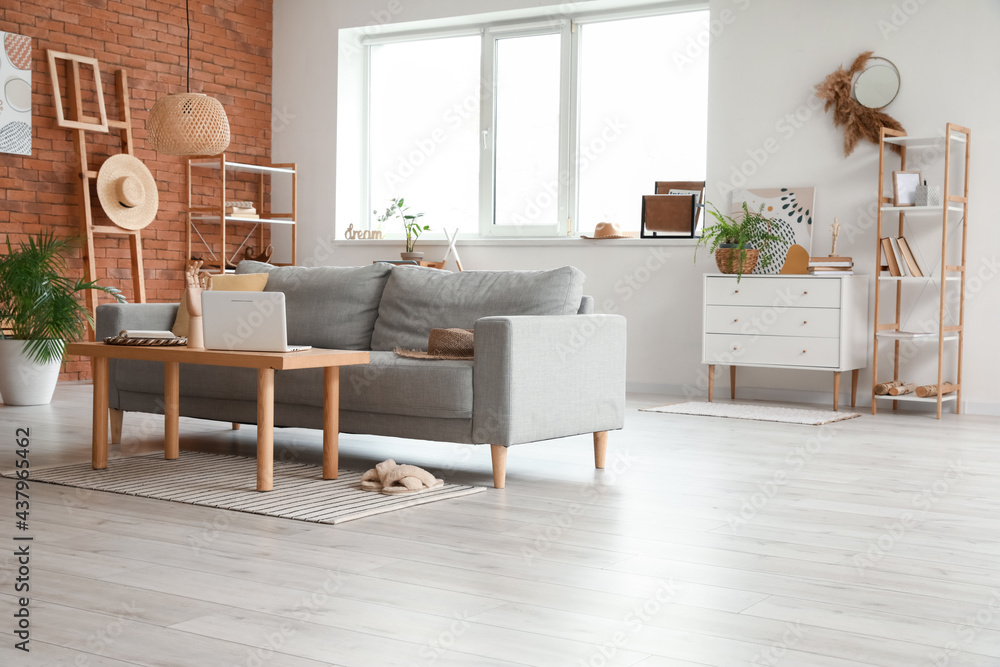 Stylish interior of living room with cozy sofa