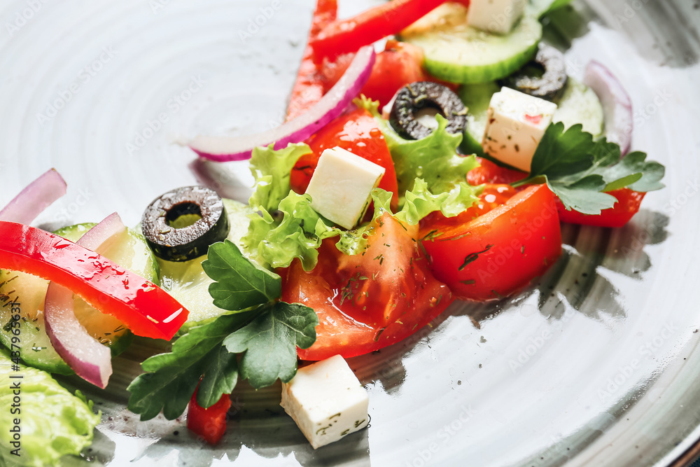 Tasty Greek salad on plate, closeup
