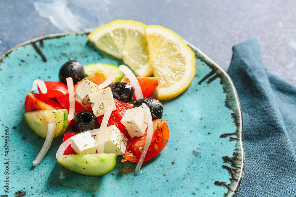 Plate of tasty Greek salad on table