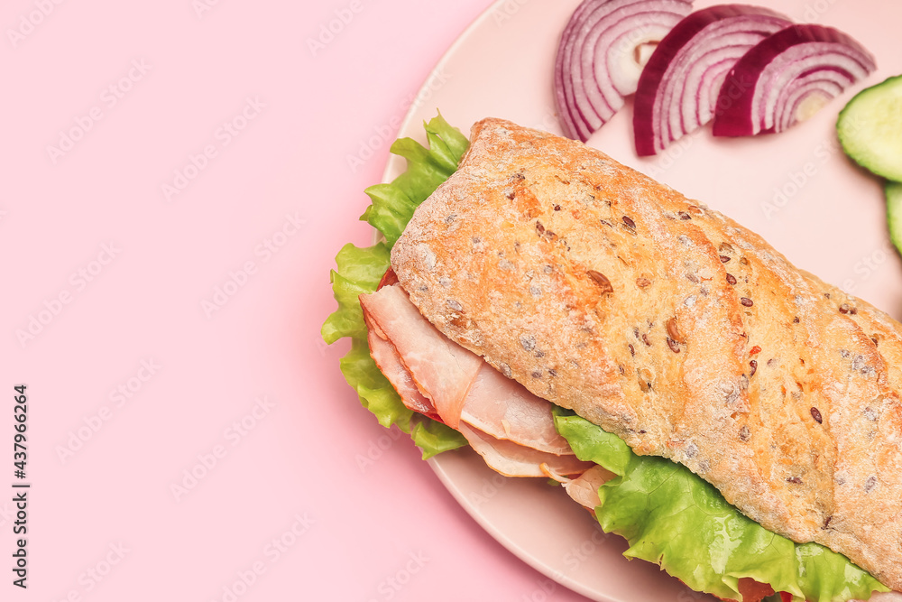 Plate with tasty ciabatta sandwich on color background