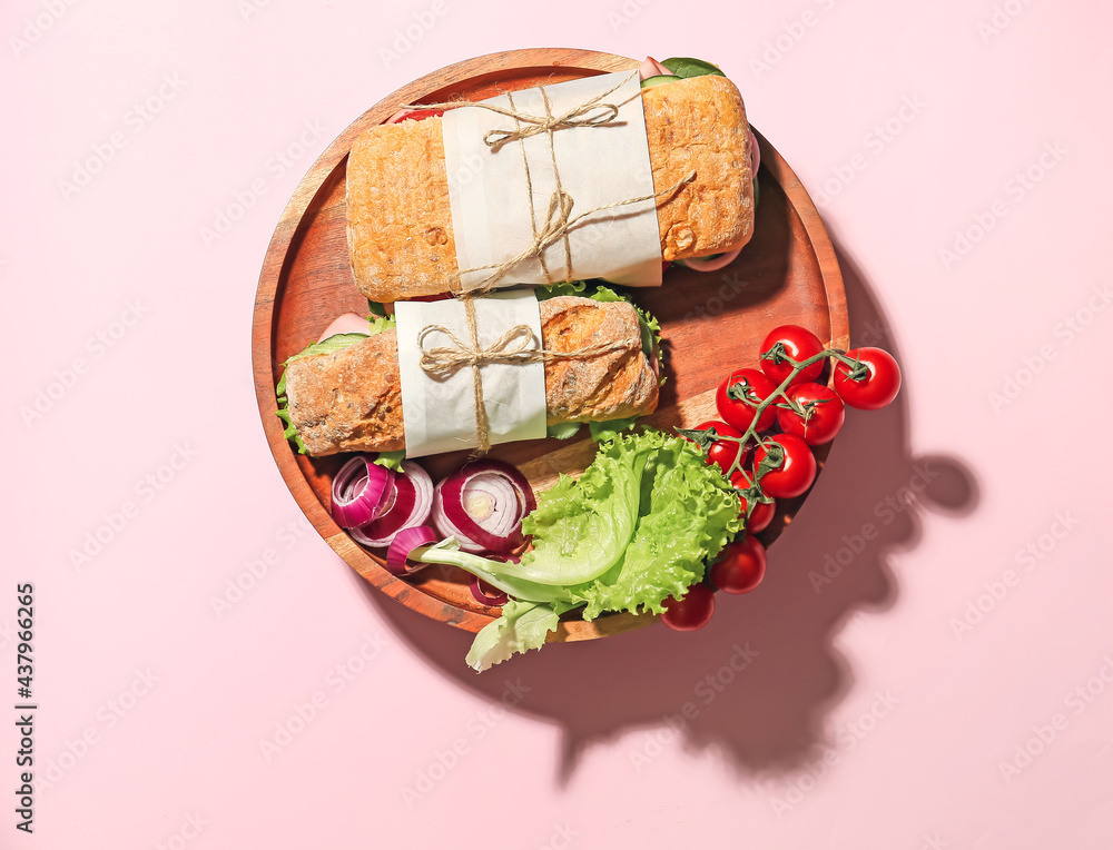 Plate with tasty ciabatta sandwiches on color background