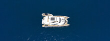 Aerial Drone Ultra Wide Photo Of Beautiful Catamaran Sail Boat Sailing In Deep Blue Sea