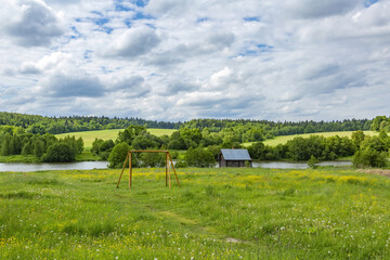 Wall Mural - Classic middle european rural landscape with flowers blooming in the meadow and beautiful sky