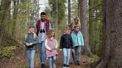 Wall Mural - Teachers with small children outdoors in nature. Learning group education concept.