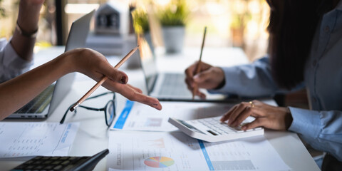 At the corporate headquarters, a business team works and discusses in a private meeting room