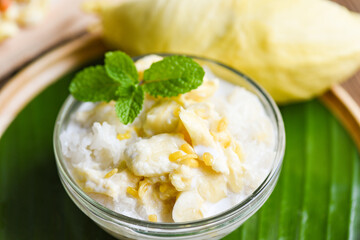 Wall Mural - Asian Thai dessert tropical sweet durian peel with yellow bean, Ripe durian rice cooked with coconut milk, Durian sticky rice summer tropical fruit food.