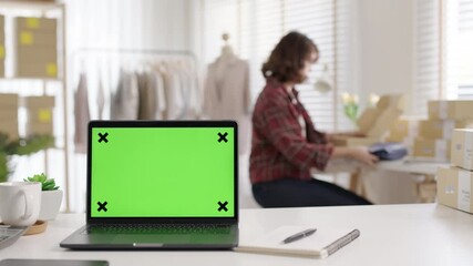 Notebook color screen on desk table at home office designer studio workplace e-commerce startup sme with asia woman female worker work background supply chain logistic delivery wifi network concept.