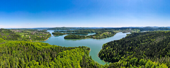 Wall Mural - Wide Panorama of Solina Lake and Green Spruce tree Forest. Aerial Drone View
