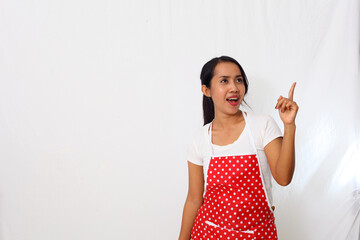 Portrait of asian woman wearing kitchen apron while getting an idea. Isolated on white background