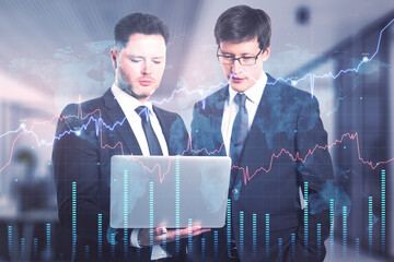 Poster - Businessmen with laptop working together in blurry office interior with forex chart. Teamwork and fintech concept. Double exposure.