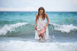 © Volodymyr - Young sexy woman at waves sea. Summer beach sensual girl. Girl in white dress on tropical beach vacation.