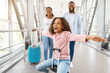 © Prostock-studio - Happy black family traveling with daughter, having fun in airport