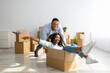 © Prostock-studio - Happy african american couple having fun and fooling while moving to new home. Joyful woman riding in cardboard box