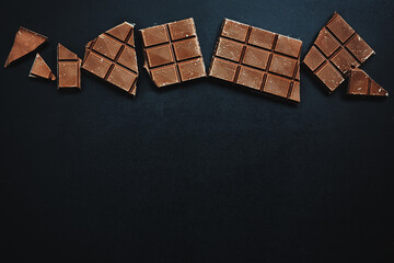 Wall Mural - Chocolate bars broken on dark background