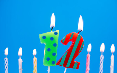 Burning birthday cake candle number 12. Happy Birthday background anniversary celebration concept