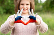© Svetlana - Kid hands painted in Russian flag color show symbol of heart and love gesture, focus on hands. Heart shape of kids hand painted in white blue red color, kids body language, children love concept.