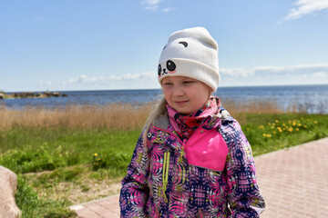 Portrait of a girl in autumn clothes by the lake