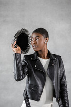 Trendy Black Model In Checkered Hat On Gray Background