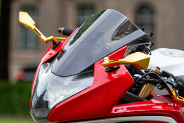 Wall Mural - closeup of the headlights of a red sports motorcycle on the street