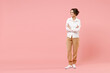 Full length young smiling happy successful employee business woman corporate lawyer in classic formal white shirt work in office hold hand crossed look aside isolated on pastel pink background studio