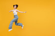 © ViDi Studio - Full length young fun happy excited woman 20s with bob haircut wearing white tank top shirt jumping high point index finger aside on copy space area mock up workspace isolated on yellow background