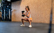 © ADDICTIVE STOCK - Fit woman exercising with dumbbells in gym