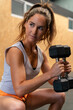 © ADDICTIVE STOCK - Fit woman exercising with dumbbells in gym
