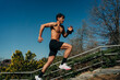 © ADDICTIVE STOCK - Fast runner jogging on stairs in park
