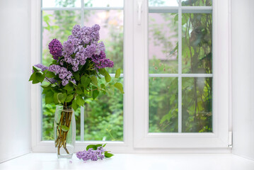 Poster - Bouquet of lilac in a vase on the windowsill