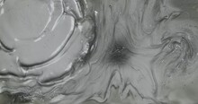 Beautiful Metallic Gray Texture. Wind Stream Blowing Away Silver Paint. Wavy Silver Abstract Liquid Background. Silver Wave Background. Silver Texture. Top View.