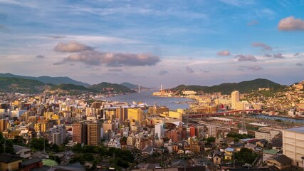 Poster - Nagasaki, Japan. Aerial timelapse made from a hill in Nagasaki, Japan, with a view over the entire center, including the bay and the hills. Cloudy and sunny day in summer