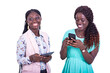 © vystekimages - two beautiful young women using a mobile phone together while smiling.