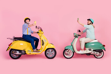 Sticker - Full size profile side photo of happy mature couple two people ride drive moped take selfie on phone isolated on pink color background