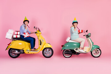 Poster - Full size profile side photo of mature couple male female scooter rider driver deliver birthday gifts isolated on pink color background