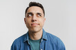 © Drobot Dean - Young brunette man dressed denim shirt thinking and looking aside