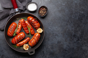 Canvas Print - Hot grilled sausages in a frying pan