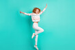© deagreez - Full length body size view of lovely thin cheerful wavy-haired girl jumping having fun isolated over bright teal turquoise color background