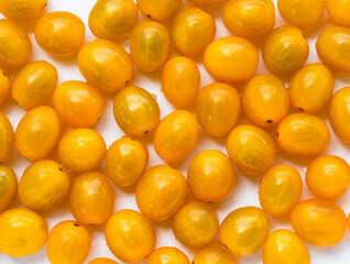 Wall Mural - High angle view of full frame image of bright yellow tomatoes. Suitable for food background or artwork.