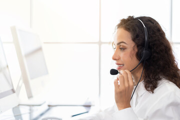 Young operator woman working in call center. Woman customer support operator with headset working in the office. Contact center and customer service by headphone concept